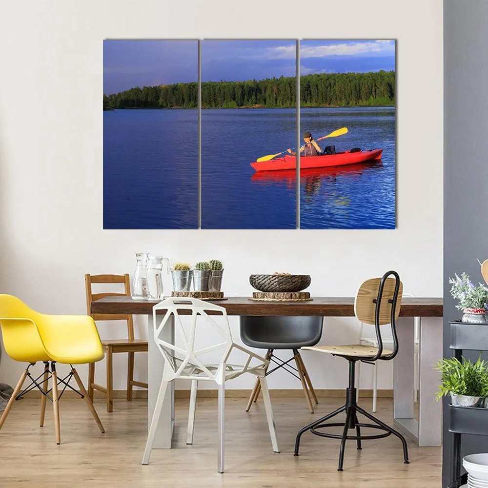 Woman Canoeing In A Beautiful Lake Canvas Wall Art