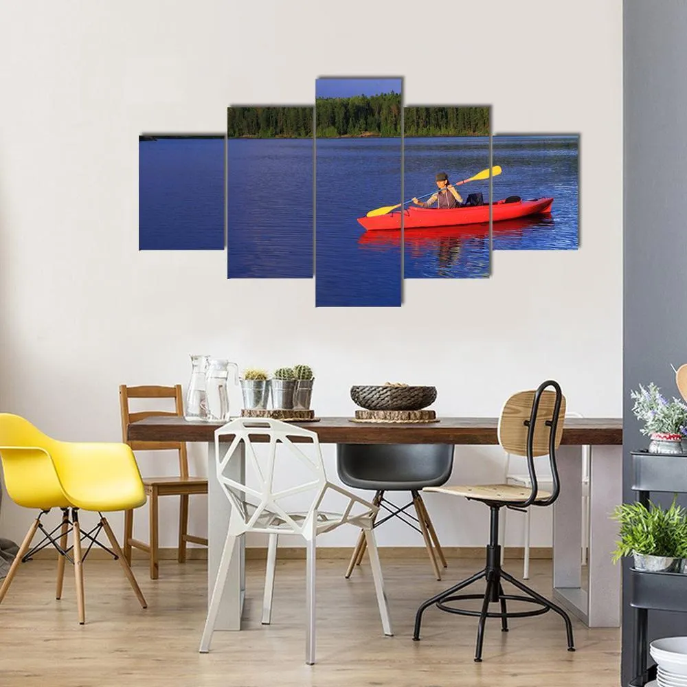 Woman Canoeing In A Beautiful Lake Canvas Wall Art